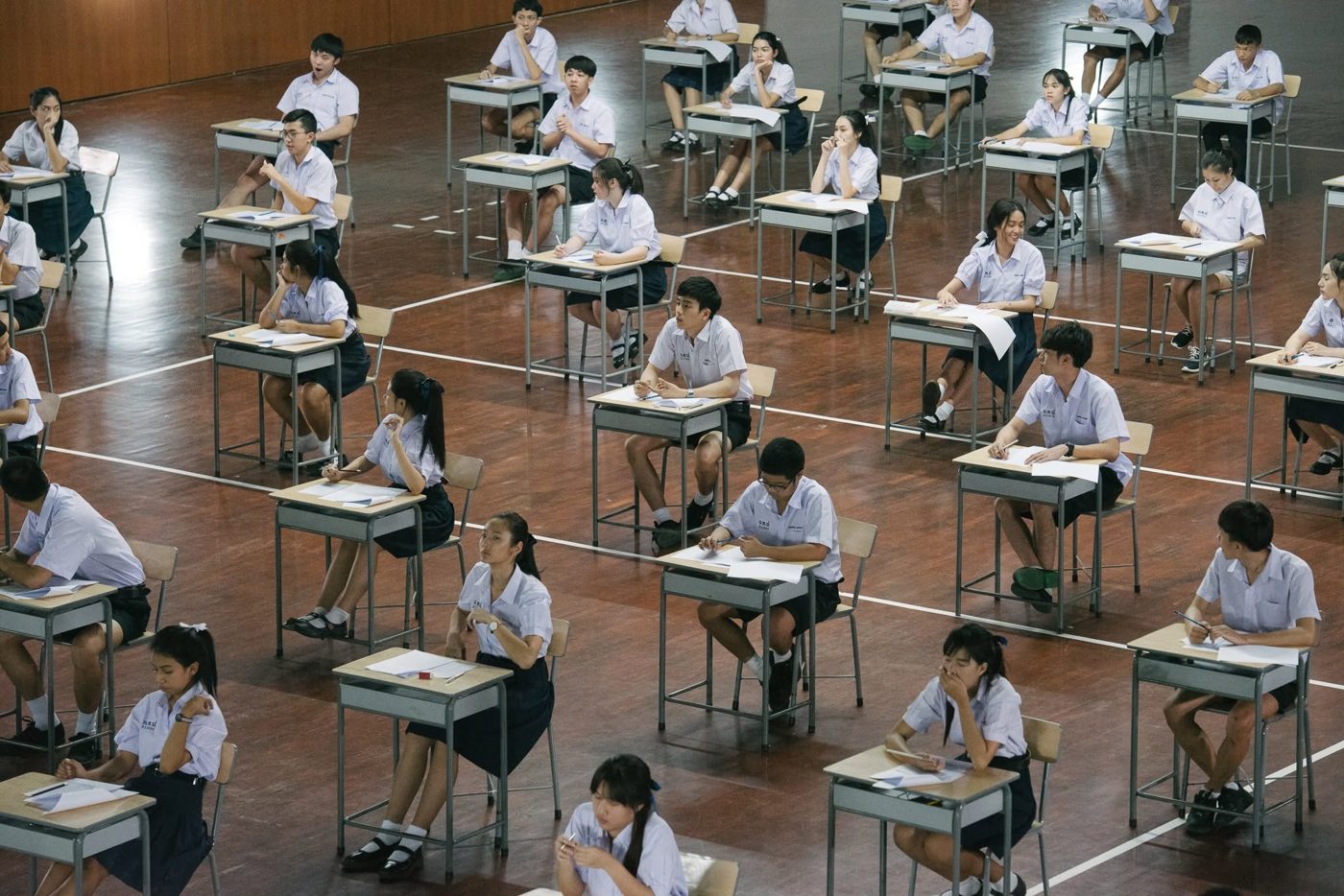 Students sitting an exam in a large hall
