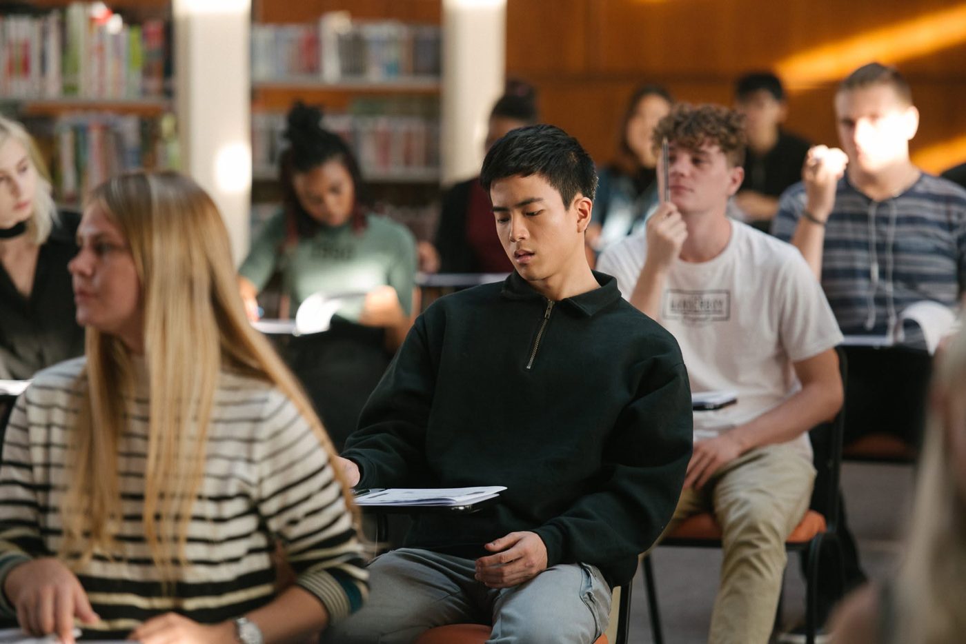 A student taking an exam in a library