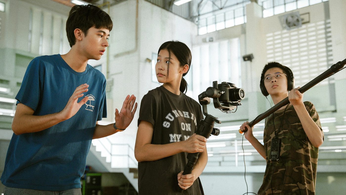 Students filming with a camera rig in a school gym