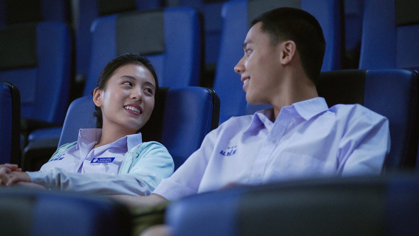 Two students smiling in a cinema