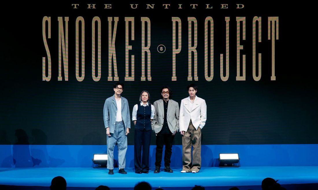 Four people standing on a blue stage beneath a screen reading The Untitled Snooker Project